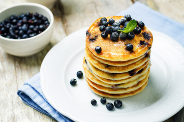 Blueberry Ricotta Pancakes with fresh blueberries and cup of coffee