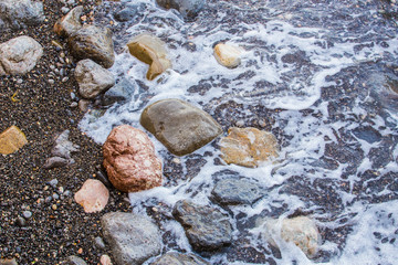 beautiful wet stones on the seashore.
