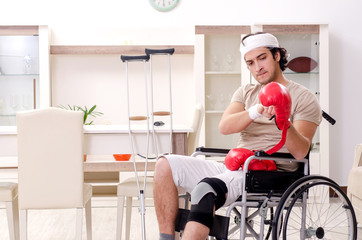 Injured young man doing exercises at home 