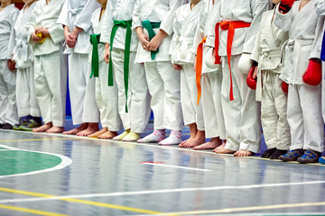 Concept karate, martial arts. Construction of students in the hall before training. Kimono,...
