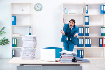 Young male employee unhappy with excessive work 