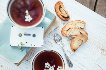 still life - cups of tea, crackers, books and cassette