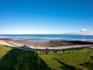 Obraz premium Beautiful landscape, Aerial view on coast of Irish Sea against clear blue sky. Drone view on beach 