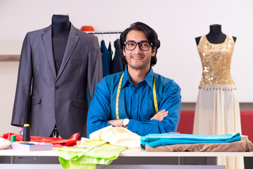 Young male tailor working at workshop 