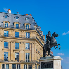     Paris, beautiful buildings place des Victoires, typical parisian facades and windows 