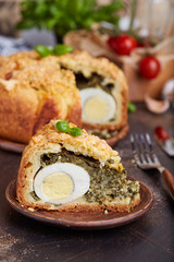 Delicious closed savory pie with eggs and spinach filling