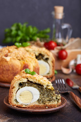 Delicious closed savory pie with eggs and spinach filling
