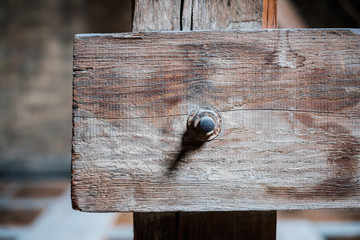 rusty screw in  wood beam closeup - construction concept background