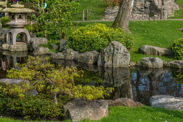Japanese garden decorated with Japanese stone lanterns, flowers and stone floors.