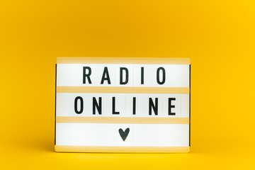 Photo of a light box with text, RADIO ONLINE, on isolated yellow background