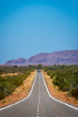 Empty long road in Western Australia leading towards Karijini National Park