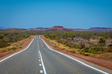 Fototapeta na wymiar Empty road in Western Australia leading towards Karijini National Park