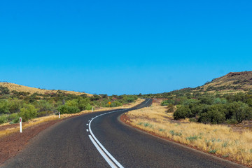 Purple iron ore sand next to road at Karijini National Park Australia