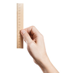 Hand holding wooden ruler, isolated on white background