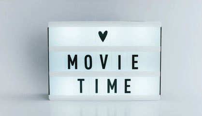Photo of a light box with text, MOVIE TIME, isolated white background