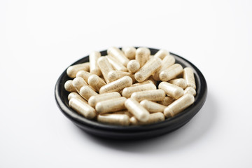 Sulforaphane capsules.  Concept for a healthy dietary supplementation. White background. Close up. Copy space.