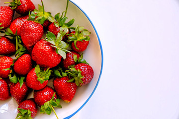 A Plate of strawberry fruits on isolated white background. Fresh and organic strawberries on isolated white