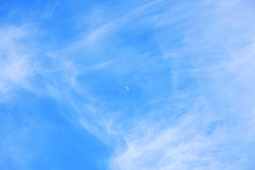 Backgraound with blue sky, moon and white couds.