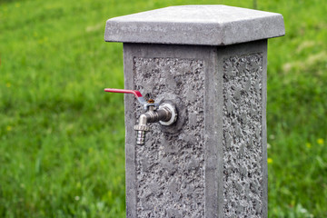 concrete fountain with a tap in the yard