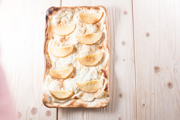 Apple pie on a wooden background