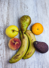 VARIED FRUIT ON WOODEN BACKGROUND