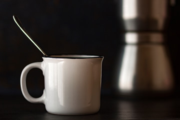 WHITE COFFEE CUP AND COFFEE MAKER IN THE FUND