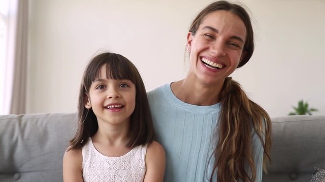 Happy mother and cute kid daughter make distant online call