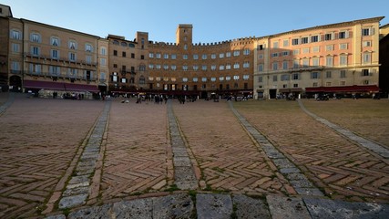 Scenic view of a section of Piazza del Campo medieval square in Siena town, Tuscany, Italy, with the brick pavement in evidence 
