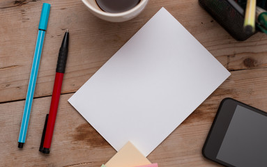 Wooden table paper stationary tablet pen coffee cup. New project challenges Design business concept Empty copy text for Web banners promotional material mock up template