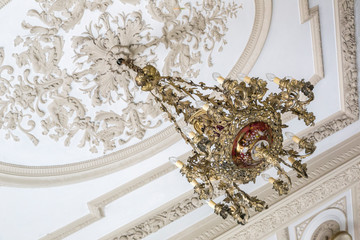 Elegant chandelier hang from the white ceiling