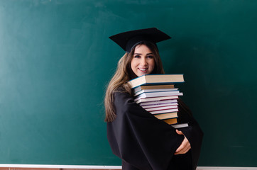 Female graduate student in front of green board 