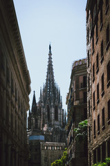 Fototapeta na wymiar Cathedral in the center of Barcelona seen between two buildings - Barcelona, Spain