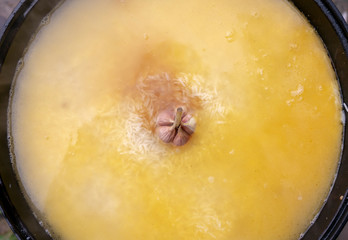 step-by-step process of cooking pilaf in a cast iron cauldron