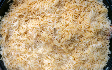 step-by-step process of cooking pilaf in a cast iron cauldron