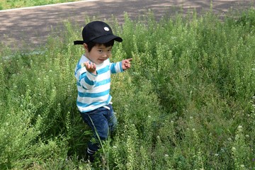 2 year old boy playing in the field