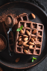 Tasty waffles with dark chocolate and nuts