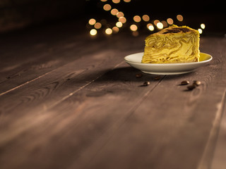 pancake cake with cream and coffee on a white saucer