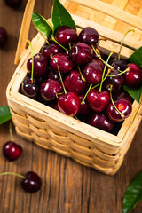 Cherries in a Wicker Basket Background. Selective focus.