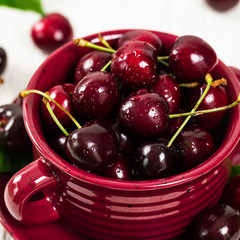 Cherries on White Wooden Background. Selective focus.