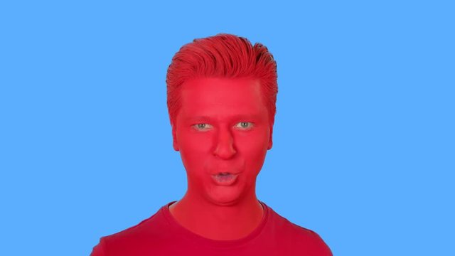 The face of men painted with red paint