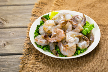 Large Raw Shrimp on Wooden Background. Selective focus.