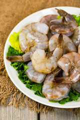 Large Raw Shrimp on Wooden Background. Selective focus.