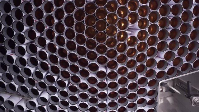 Close-up Tray conveyor vertical feed tubes for the packaging of toothpaste, hair dye, medical preparations. Sterile high-precision modern equipment for the production of medical and cosmetic products