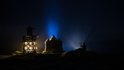 Ornamental Arabic lantern with burning candle glowing at night. Festive greeting card, invitation for Muslim holy month Ramadan Kareem.