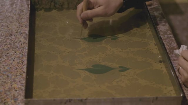 Ebru artist painting a new artwork, ab01