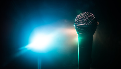 Microphone karaoke, concert . Vocal audio mic in low light with blurred background. Live music, audio equipment. Karaoke concert, sing sound. Singer in karaokes, microphones.