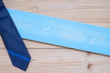 blue necktie on wooden background with copy space for text. Happy Father's Day and International Men's Day concepts