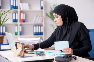 Female employee bookkeeper in hijab working in the office 