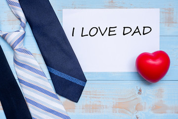 I Love DAD with blue neckties and red heart shape on wooden background. Happy Father's Day and International Men's Day concepts