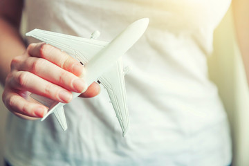 Female woman hands holding small toy model plane. Travel by plane vacation weekend adventure trip journey ticket tour aviation delivery concept. Symbol of international freedom